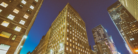 Night view of New York buildings from street level.の写真素材