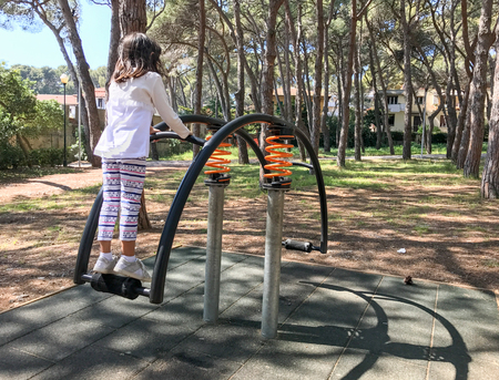 Baby enjoying seesaw in the city park.の写真素材
