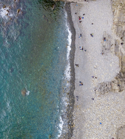Panoramic overhead view of beautiful beach with people and waves.の写真素材