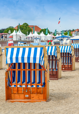 TRAVEMUNDE, GERMANY - JULY 22, 2016: Beach chairs with locals and tourists. Travemunde is a famous destination on the Baltic coast.のeditorial素材