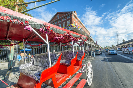 NEW ORLEANS, USA - FEBRUARY 2016: Red horse carriage along Jackson Square. New Orleans attracts 10 million tourists annually.のeditorial素材