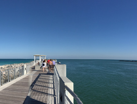 MIAMI, FL - FEBRUARY 2016: Tourists along South Pointe Park Wooden Pier. Miami attracts 15 million people annually.のeditorial素材