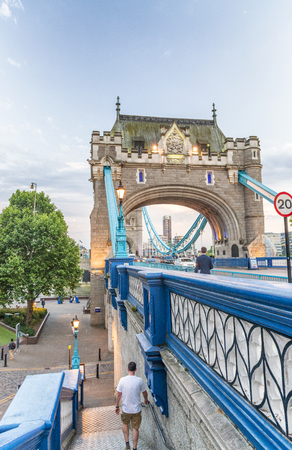 LONDON - MAY 2013: Tourists near Tower Bridge. London attracts 30 million tourists annually.のeditorial素材