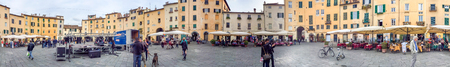 LUCCA, ITALY - APRIL 2015: Tourists along city square, panoramic view. Lucca is a major destination in Tuscany.のeditorial素材