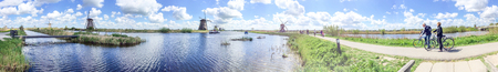 KINDERDIJK, THE NETHERLANDS - APRIL 2015: Tourists visit famous windmills. This is a major tourist attraction in Holland.のeditorial素材