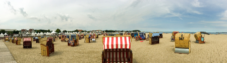 TRAVEMUNDE, GERMANY - JULY 2016: Tourists enjoy city beach. Travemunde is a famous sea town in Germany.のeditorial素材