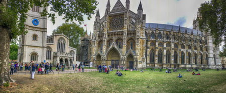 LONDON - SEPTEMBER 2016: Tourists walk near Westminster Abbey. London attracts 30 million people annually.のeditorial素材