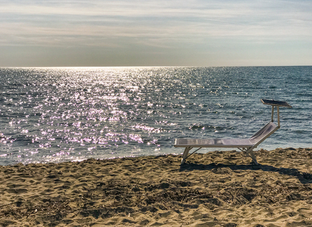 Beach bed along the ocean at sunset.の写真素材