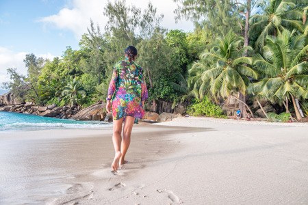Beautiful woman walking on a beautiful beach.の写真素材