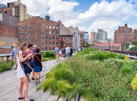 NEW YORK CITY - JUNE 2013: People move along High Line city park. It is a famous city attraction.