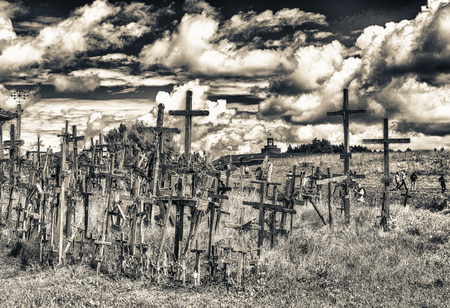 SIAULIAI, LITHUANIA - JULY 9, 2017: Tourists and pilgrims visit Hill of Crosses. The Hill Of Crosses in northern Lithuania has been a site of pilgrimage for hundreds of years.のeditorial素材
