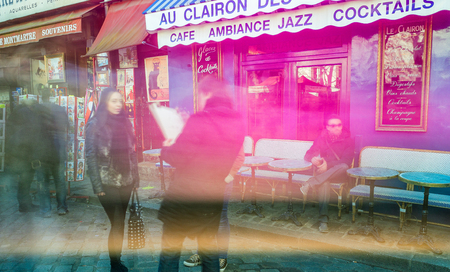 PARIS, FRANCE - DECEMBER 2012: Tourists visit Montmartre art district, long exposure shot. The city attracts 40 million people every year.のeditorial素材