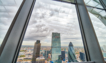 City of London framed by skyscraper window glasses.のeditorial素材