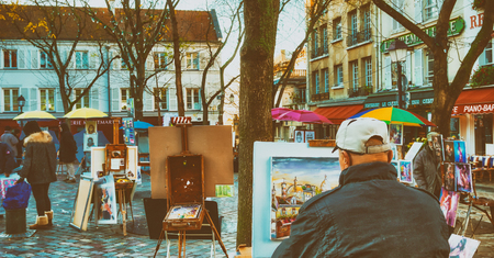 PARIS, FRANCE - DECEMBER 2012: Tourists visit Montmartre art district. The city attracts 40 million people every year.のeditorial素材
