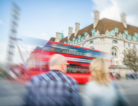 LONDON - SEPTEMBER 25, 2016: Colourul bus speeds up along Westminster Bridge. London attracts 30 million tourists annually.のeditorial素材