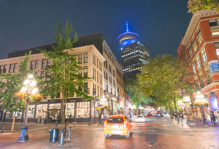 VANCOUVER, CANADA - AUGUST 8, 2017: Tourists at night in Gastown. It is the original settlement that became the core of the creation of Vancouver.のeditorial素材