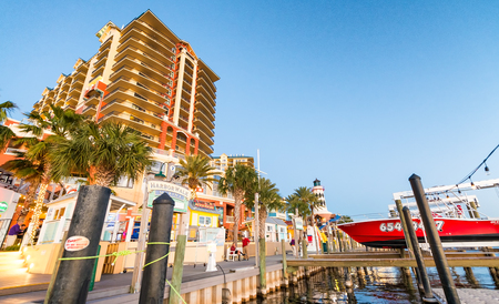 DESTIN, FL - FEBRUARY 13, 2016: Harborwalk Marina with tourists at dusk. This is a famous tourist attraction.のeditorial素材