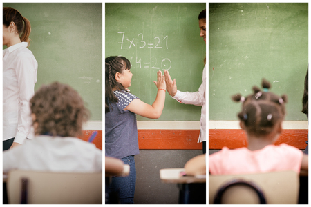 Female teacher with classroom at elementary school.の写真素材