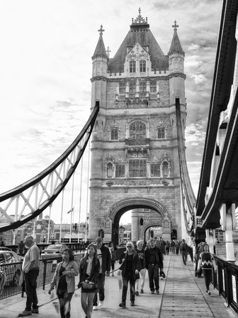 LONDON - SEPTEMBER 25, 2016: Tourists visit the Tower Bridge. London attracts 30 million people annuallyのeditorial素材