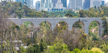 SAN DIEGO - JULY 30, 2017: Bridge and San Diego skyline with trees on foreground.のeditorial素材