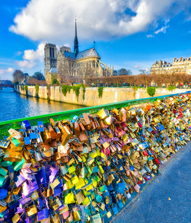 PARIS, FRANCE - DECEMBER 2012: Tourists visit Pont de L'Archeveche. The city attracts 40 million people every year.のeditorial素材