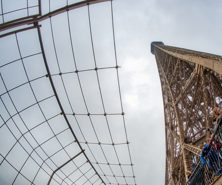 PARIS, FRANCE - DECEMBER 2012: Tourists visit Eiffel Tower, wide angle view. The city attracts 40 million people every year.のeditorial素材