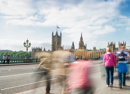 LONDON - SEPTEMBER 29, 2013: Tourists walk along Westminster Bridge, long exposure view. London attracts 30 million visitors every year.のeditorial素材