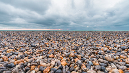 Pebbles on a beautiful beach during a storm.の写真素材
