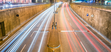 Tunnel entrance car light trails at night.の写真素材