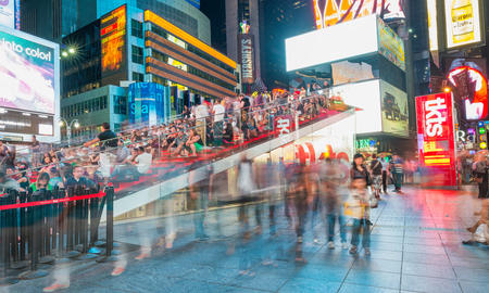 NEW YORK CITY - JUNE 15, 2013: Tourists in Times Square at night. New York attracts 50 million tourists every year.のeditorial素材