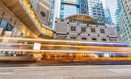HONG KONG - MAY 12, 2014: Downtown skyscrapers with road car light trails at night. Hong Kong attracts 25 million people annually.のeditorial素材
