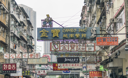 HONG KONG - APRIL 2014: City street full of shop signs. Hong Kong attracts 25 million people annually.のeditorial素材