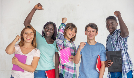 Multi ethnic group of teenagers happy standing against white background.の写真素材