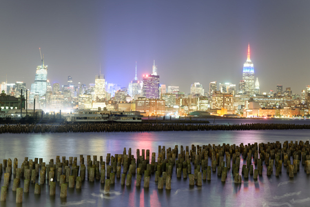 Downtown Manhattan at night as seen from Jersey City.の写真素材