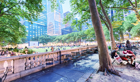 NEW YORK CITY - JUNE 8, 2013: Tourists relax in Bryant Park at night. New York attracts 50 million people every year.のeditorial素材