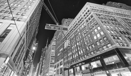 NEW YORK CITY - OCTOBER 24, 2015: Beautiful street view of Midtown Manhattan skyscrapers at night. New York attracts 50 million tourists every year.のeditorial素材