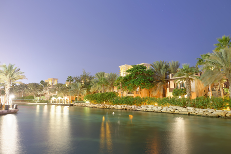 DUBAI, UAE - DECEMBER 9, 2016: Night view of Madinat Jumeirah buildings reflections. The city attracts 30 million tourists annually.のeditorial素材