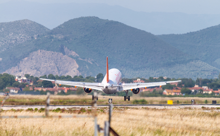 PISA, ITALY - JUN 1: Easyjet airplane lands at Pisa airport, June 1, 2013 in Pisa, Italy. Easyjet is one on the major low cost airplane company in Europe.のeditorial素材