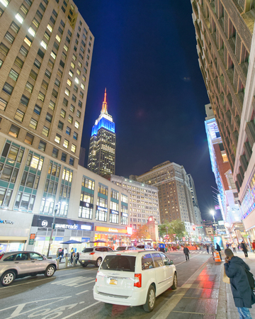 NEW YORK CITY - OCTOBER 20, 2015: Tourists at night along city streets. New York attracts 50 million people every year.のeditorial素材
