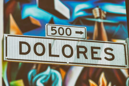 Dolores Street Road in San Francisco with blurred street art on the background.のeditorial素材