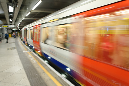 LONDON - SEPTEMBER 26, 2016: Train speeds up in city subway. The system has 270 stations and 250 miles of tracks.のeditorial素材