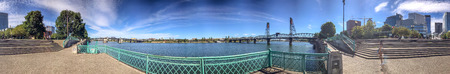 PORTLAND, OR - AUGUST 18, 2017: Panoramic view of city park along the river. Portland attracts 5...