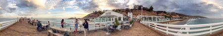 MALIBU, CA - AUGUST 1, 2017: Tourists in Malibu Pier at sunset. Malibu is a famous tourist...