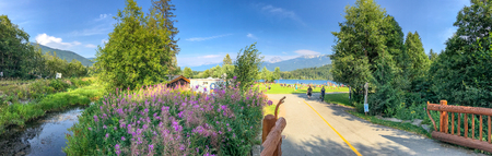 WHISTLER, CANADA - AUGUST 12, 2017: Tourists enjoy Rainbow Park Lake. Whistler is a famous winter skiing destination in Canada.のeditorial素材
