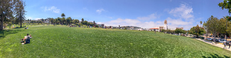 SAN FRANCISCO - AUGUST 5, 2017: Tourists enjoy relax time in Mission Dolores Park. The city attracts 25 million people annually.のeditorial素材