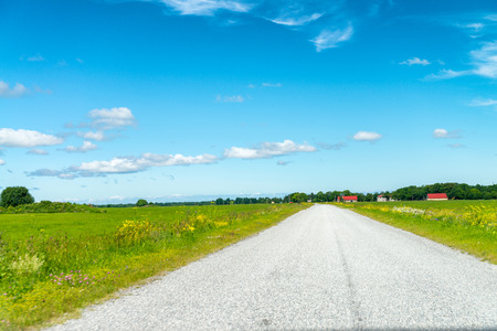 Road across beautiful countryside in summer season.
