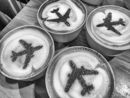 Four cups of coffee with airplane silhouettes. Vacation, holiday, travel concept.の写真素材