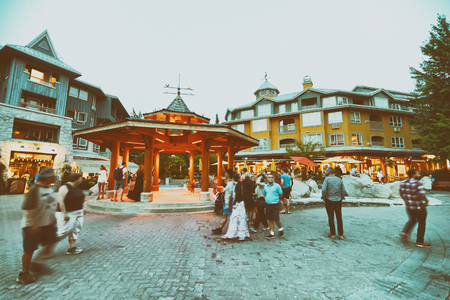 WHISTLER, CANADA - AUGUST 12, 2017: Tourists visit city streets on a summer evening. Whistler is a famous mountain destination.のeditorial素材