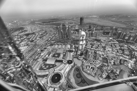 DUBAI, UAE - DECEMBER 4, 2016: Night aerial view of Downtown buildings near Burj Khalifa. Dubai attracts 30 million tourists annually.のeditorial素材