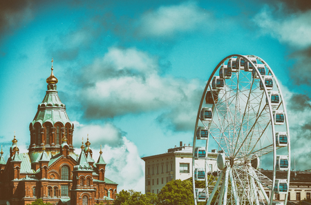 HELSINKI, FINLAND - JULY 4, 2017: Uspenski Cathedral and Ferris Wheel. Helsinki hosts 3 million tourists annually.のeditorial素材